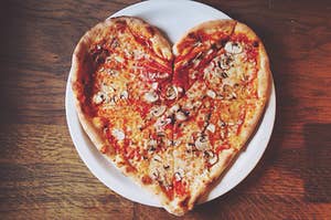 a heart shaped mushroom pizza on a plate