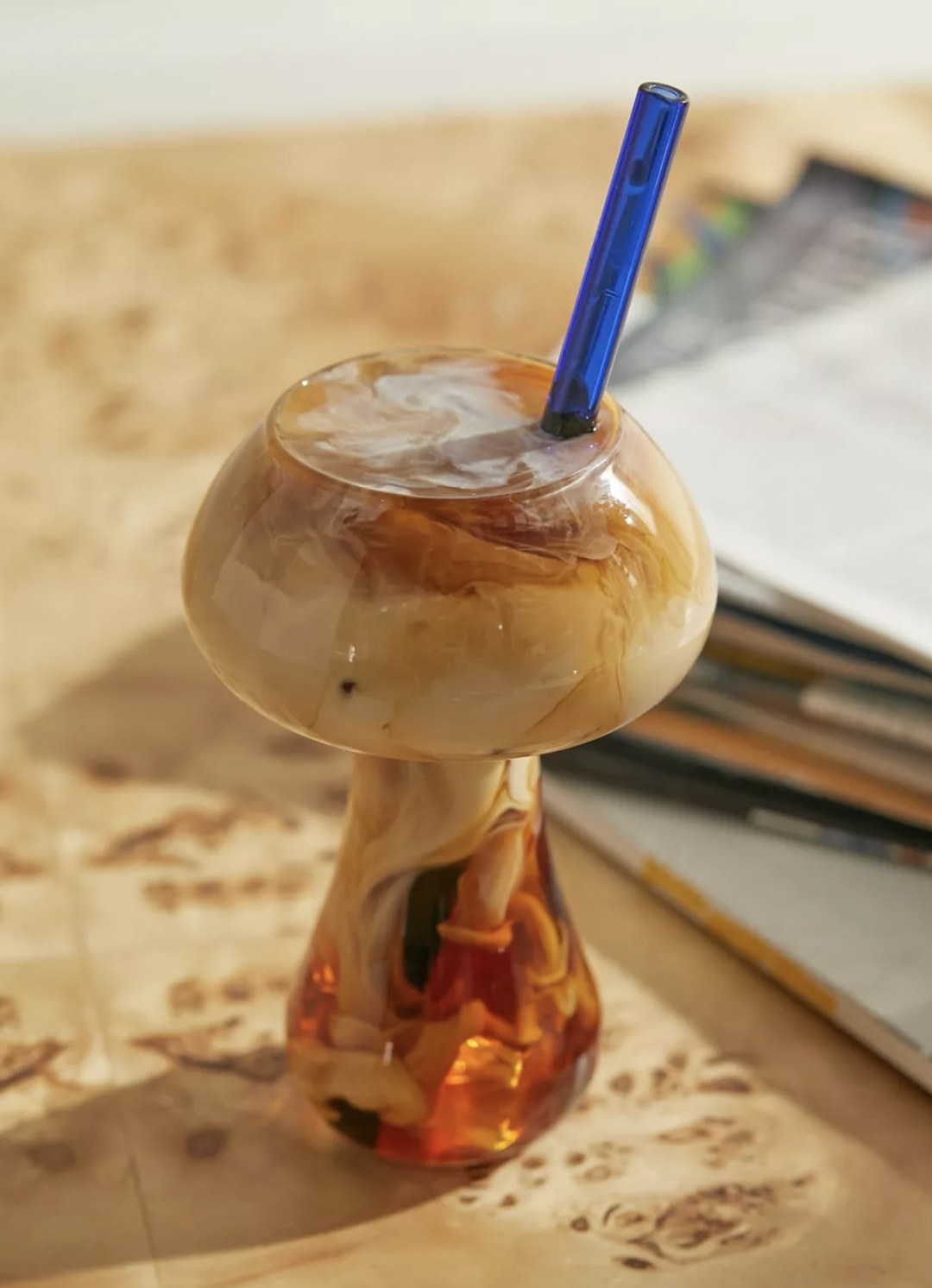 the mushroom glass with iced coffee in it