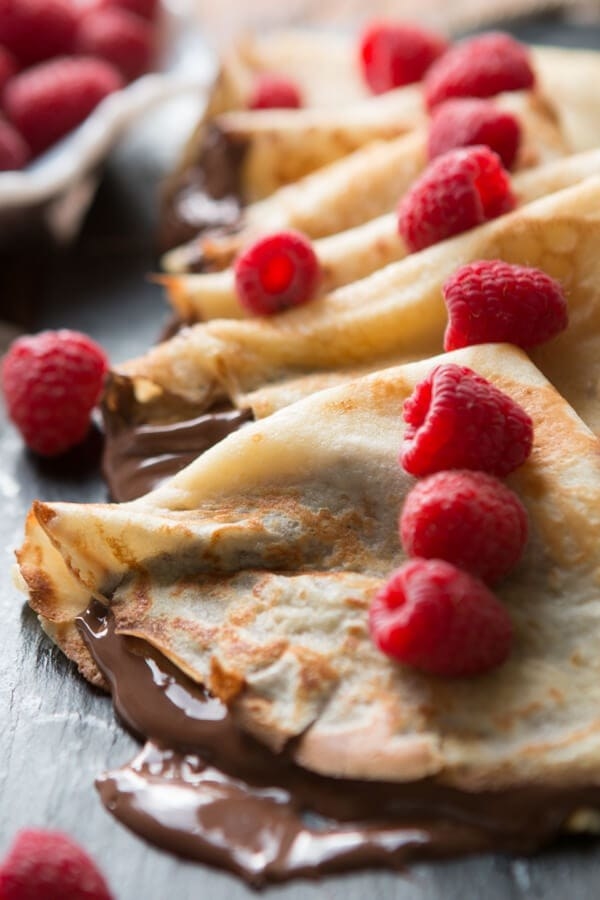 Nutella crepes topped with raspberries