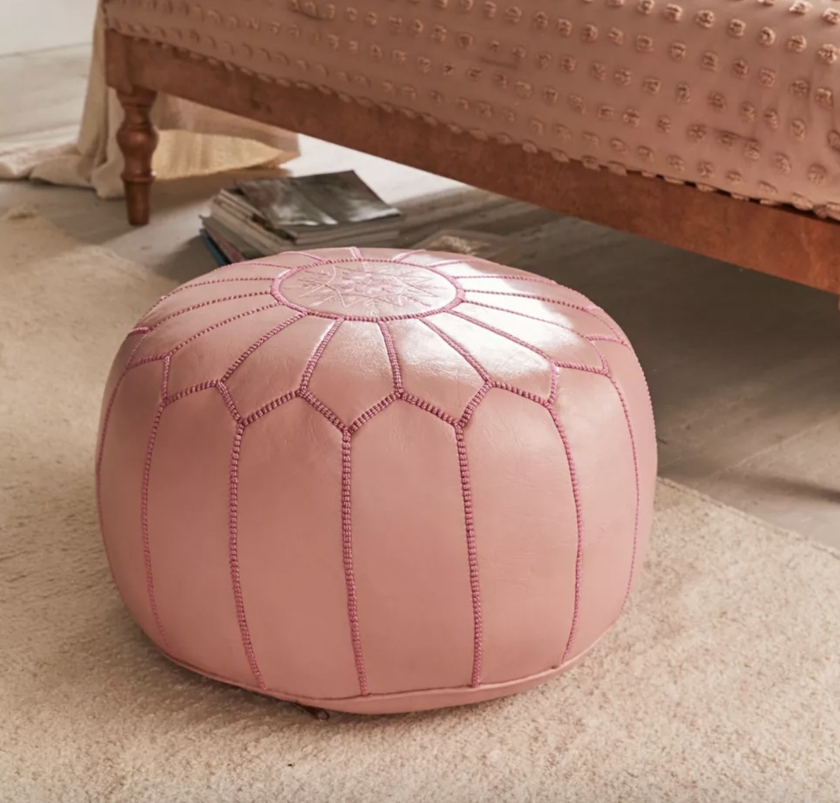 A pink leather floor pouf
