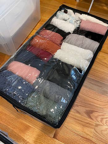 the storage bin filled with folded up clothes