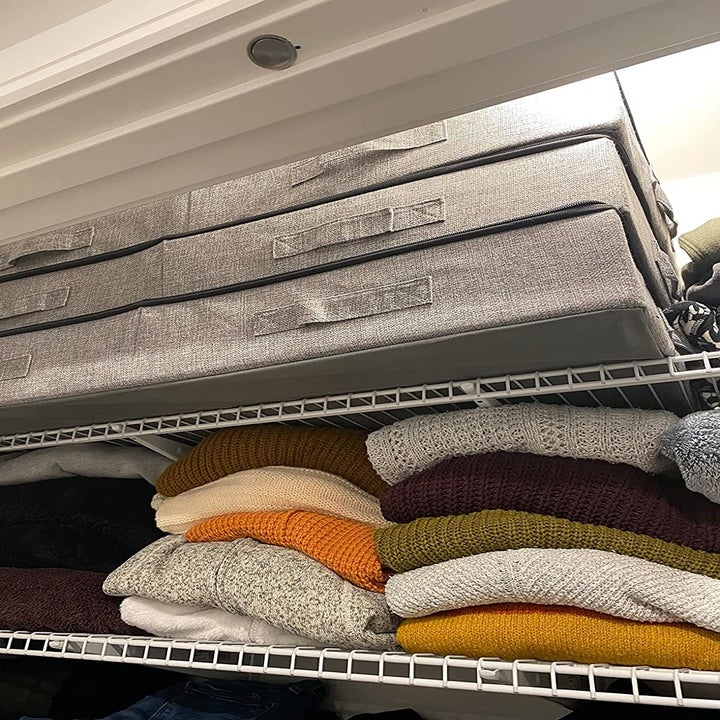 three of the bins stacked inside a closet