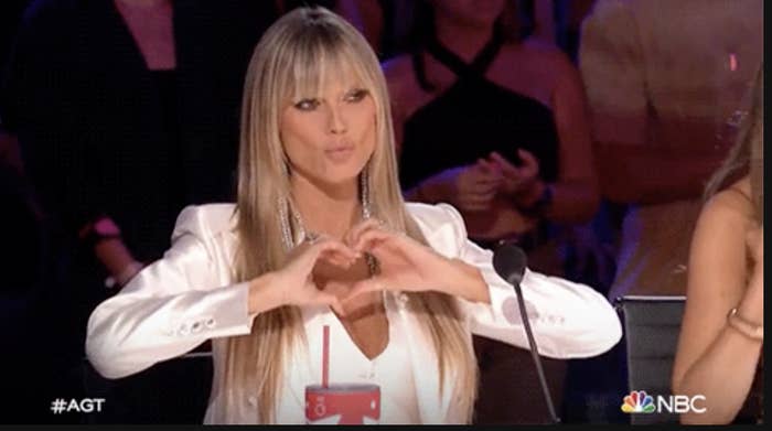 heidi klum making a heart in front of her chest
