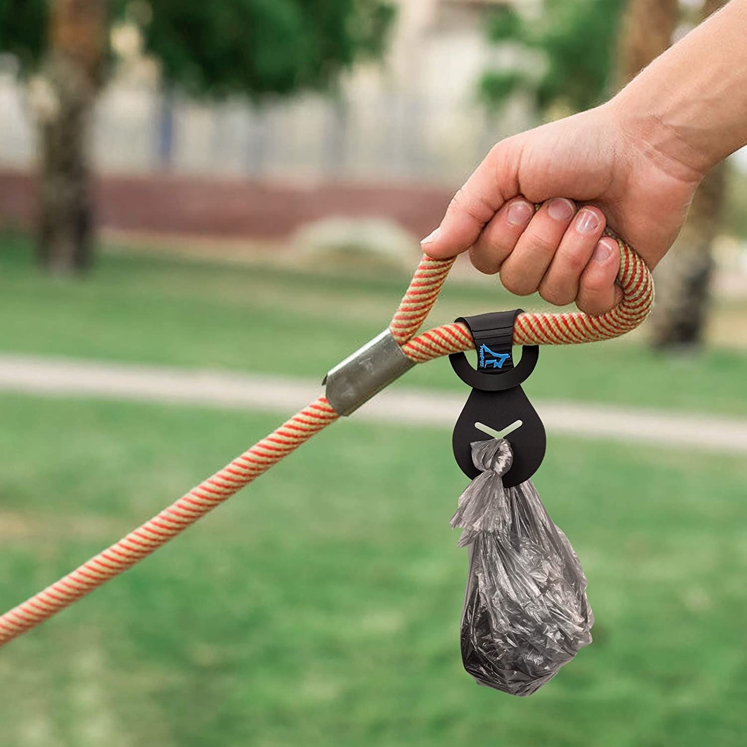 The bag carrier holding a poop bag on a leash