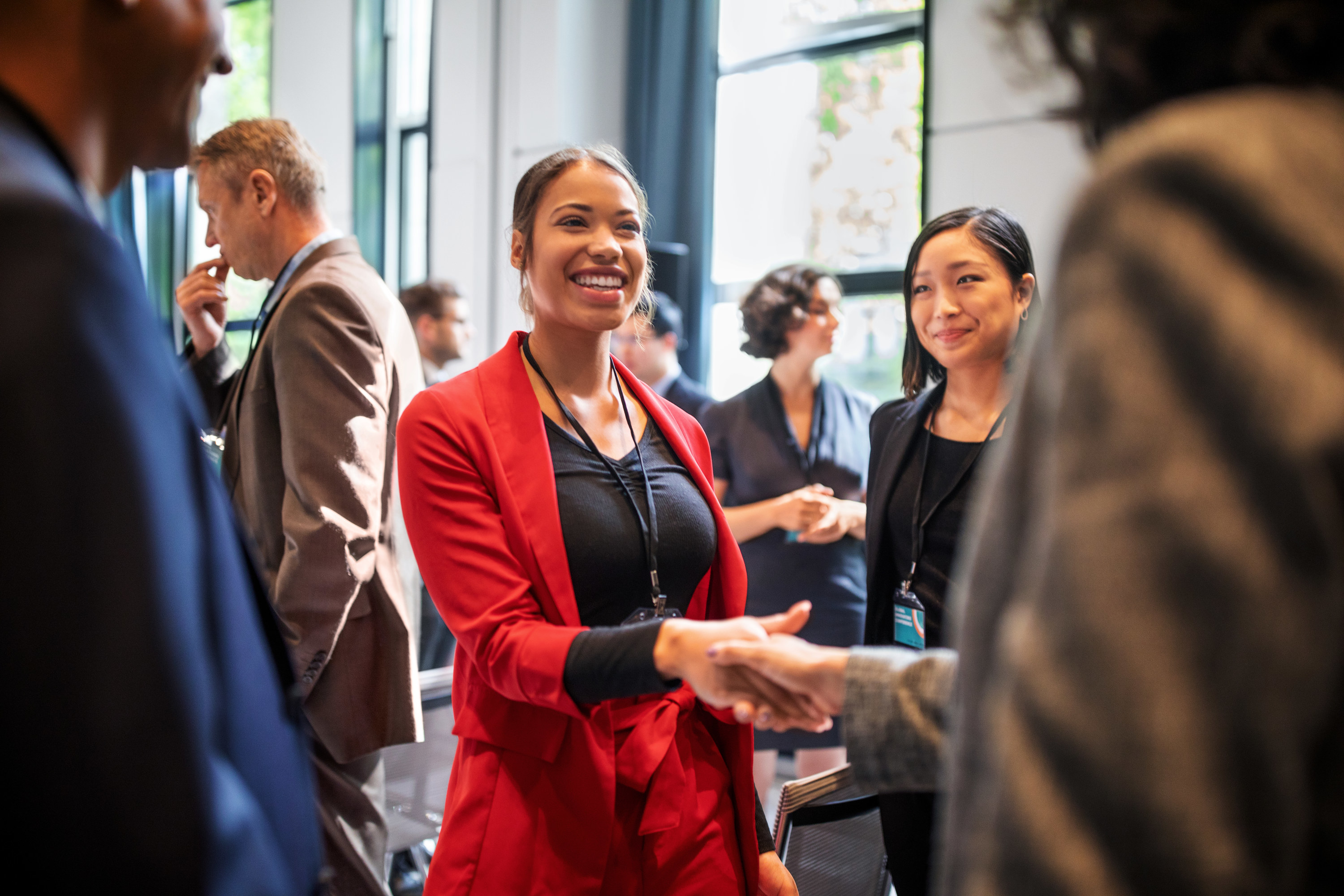 women shaking hands at a networking event