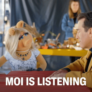 Gif of Miss Piggy from the show &quot;Holey Moley&quot; telling actor Rob Riggle &quot;moi is listening&quot;
