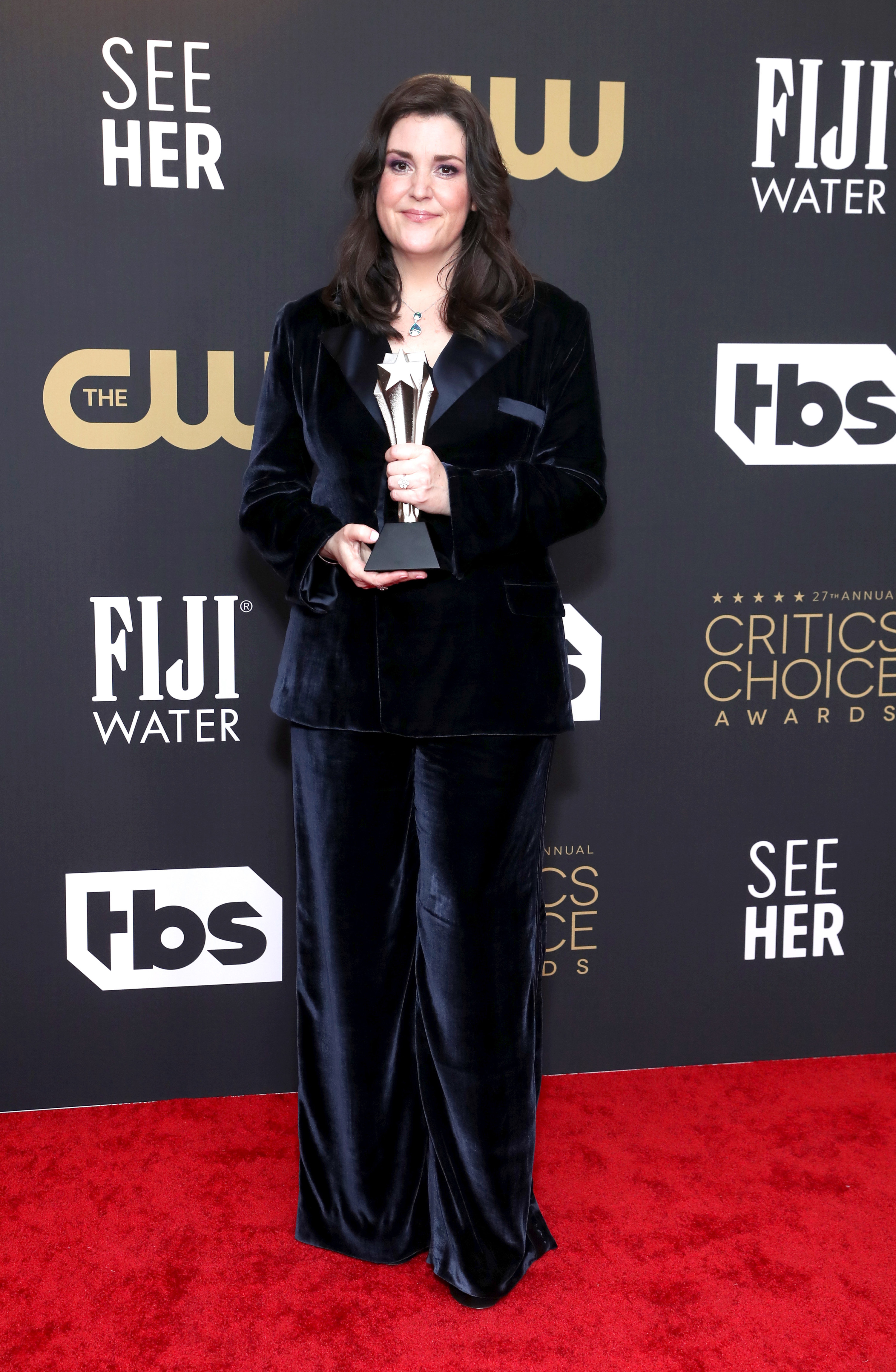 Melanie on the red carpet holding a Critics Choice award