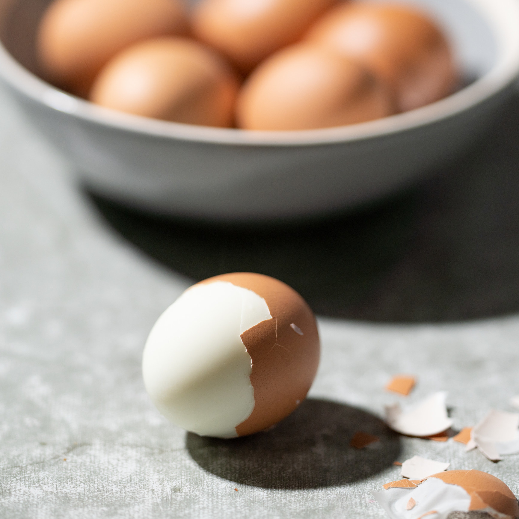 Partially peeled hard-boiled egg.