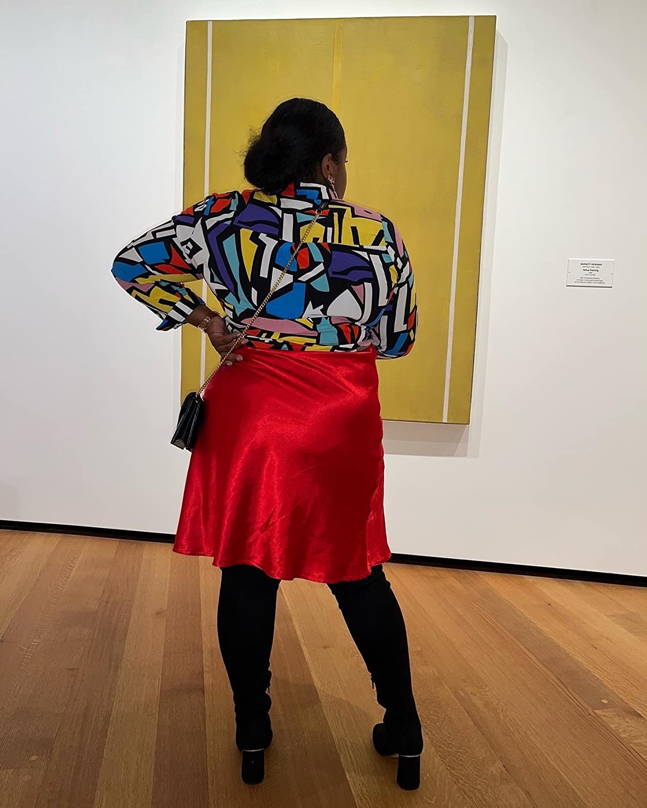 Reviewer wearing the colorful blouse with a red skirt