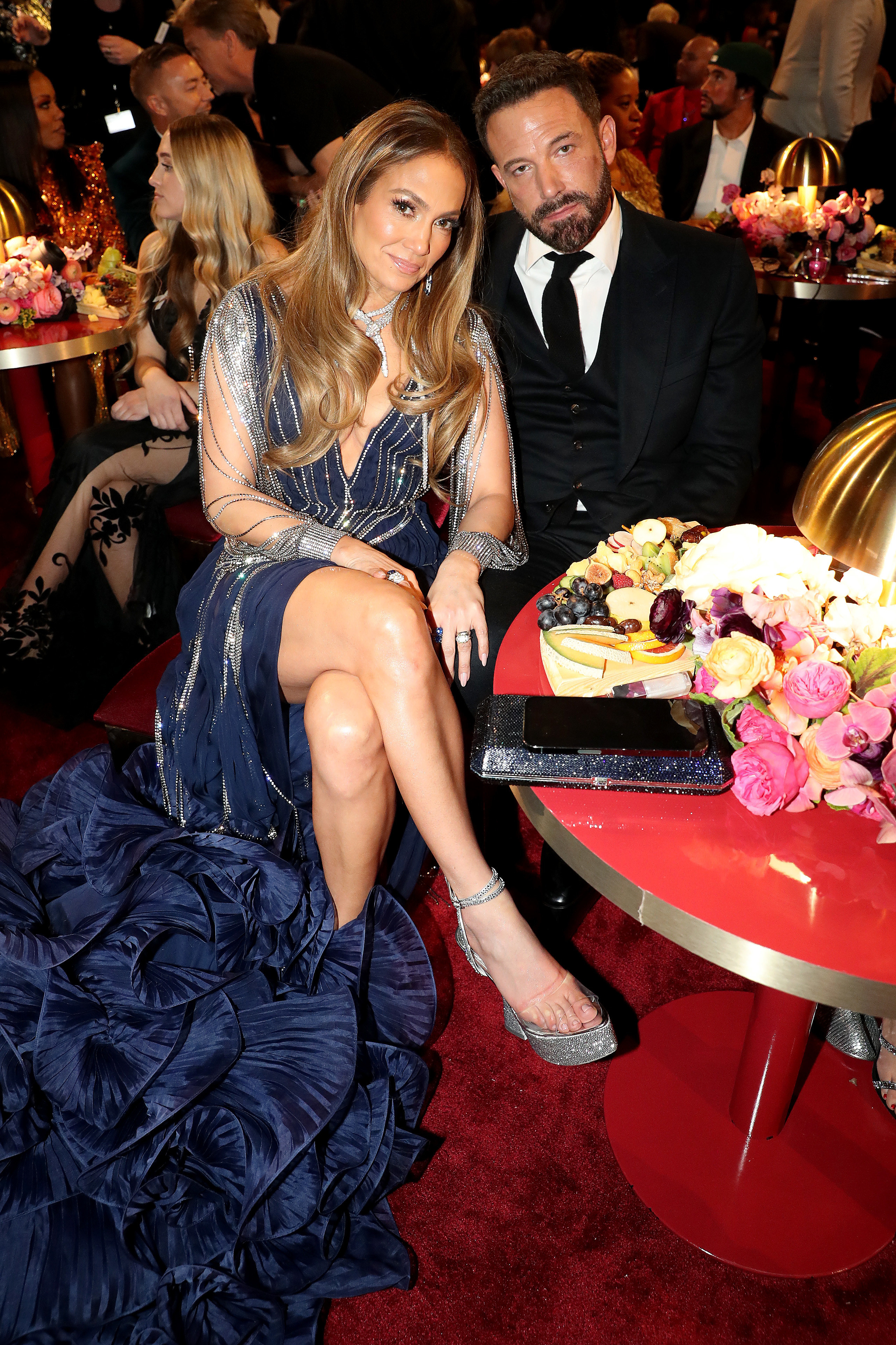 the couple sitting at a table during an awards show