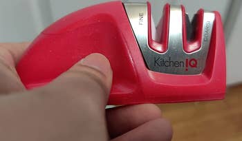 Reviewer holding the red knife sharpener to show the small size