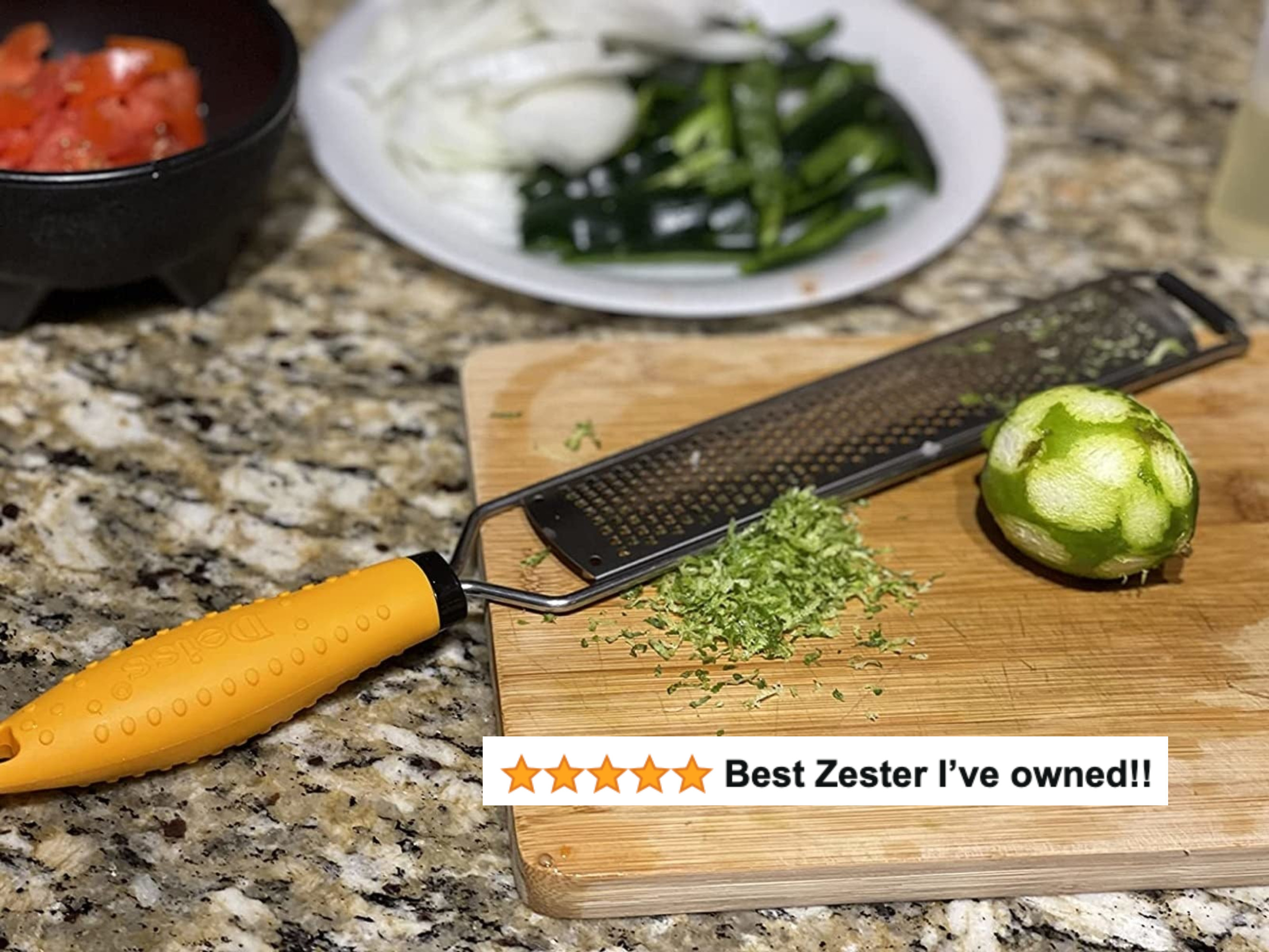 A reviewer&#x27;s zested lime next to the microplane with five star text &quot;best zester I&#x27;ve owned!!&quot;