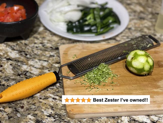 A reviewer's zested lime next to the microplane with five star text 