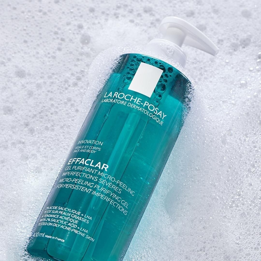 a bottle of la roche posay cleanser laying in suds