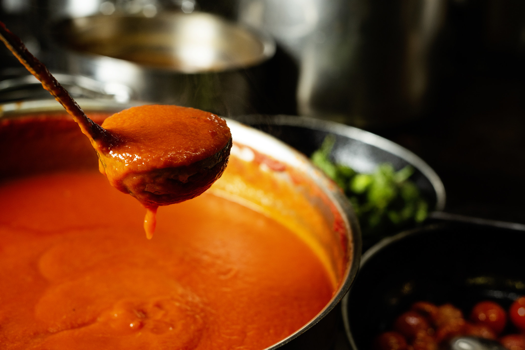 A ladle of tomato sauce.