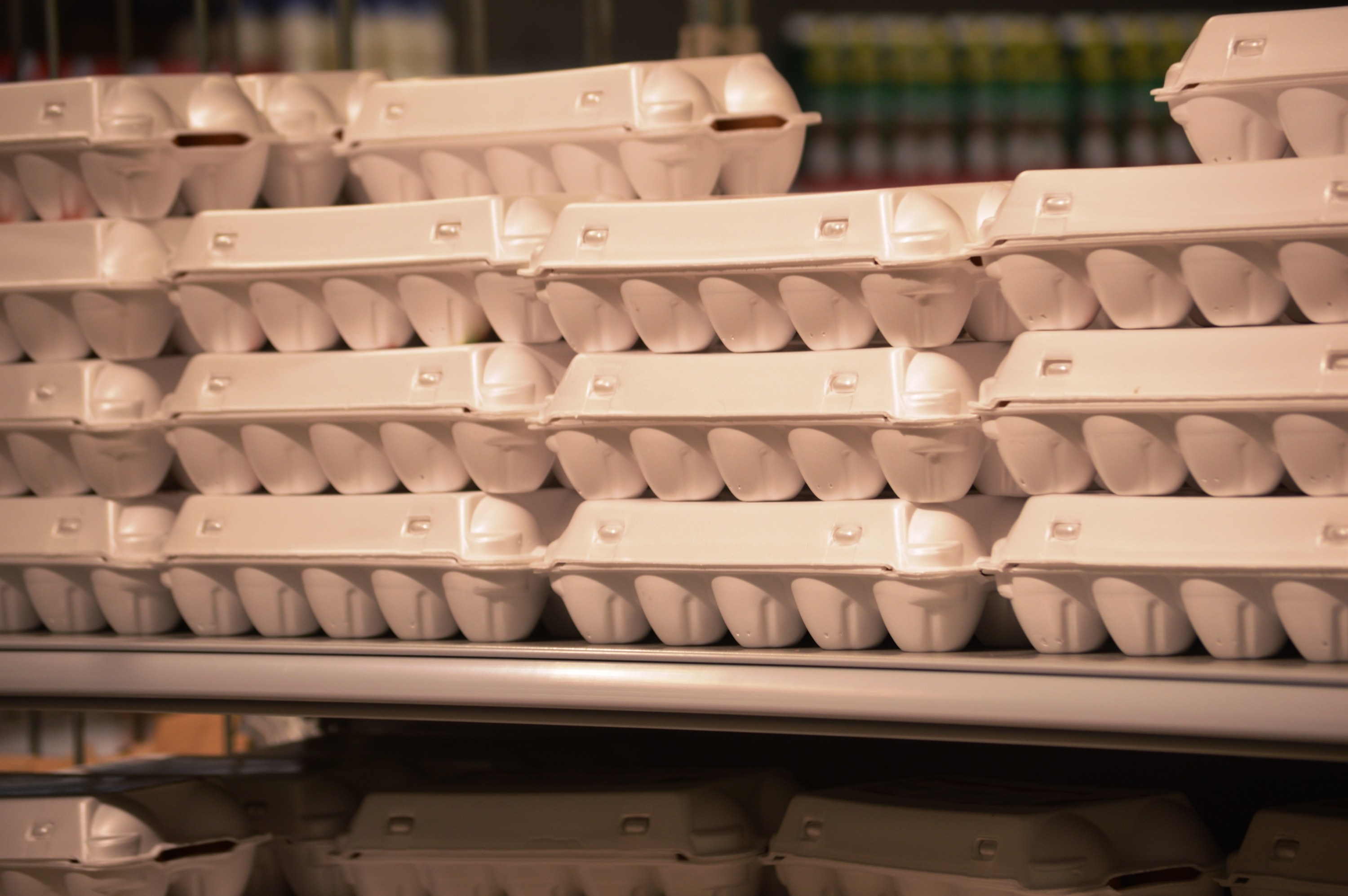 sale of chicken eggs in boxes on the shelves in the supermarket