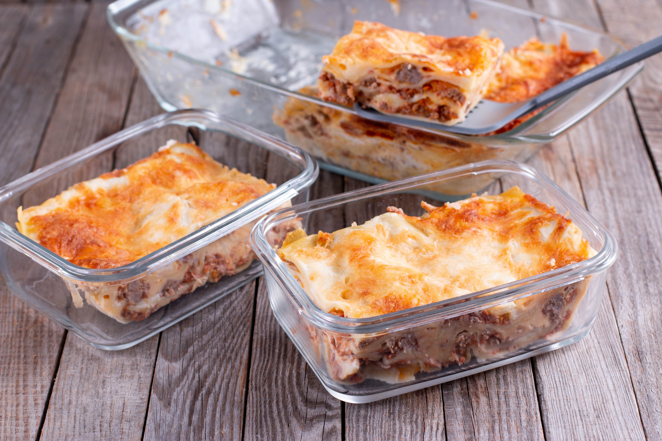 Frozen lasagne or casserole in glass containers.