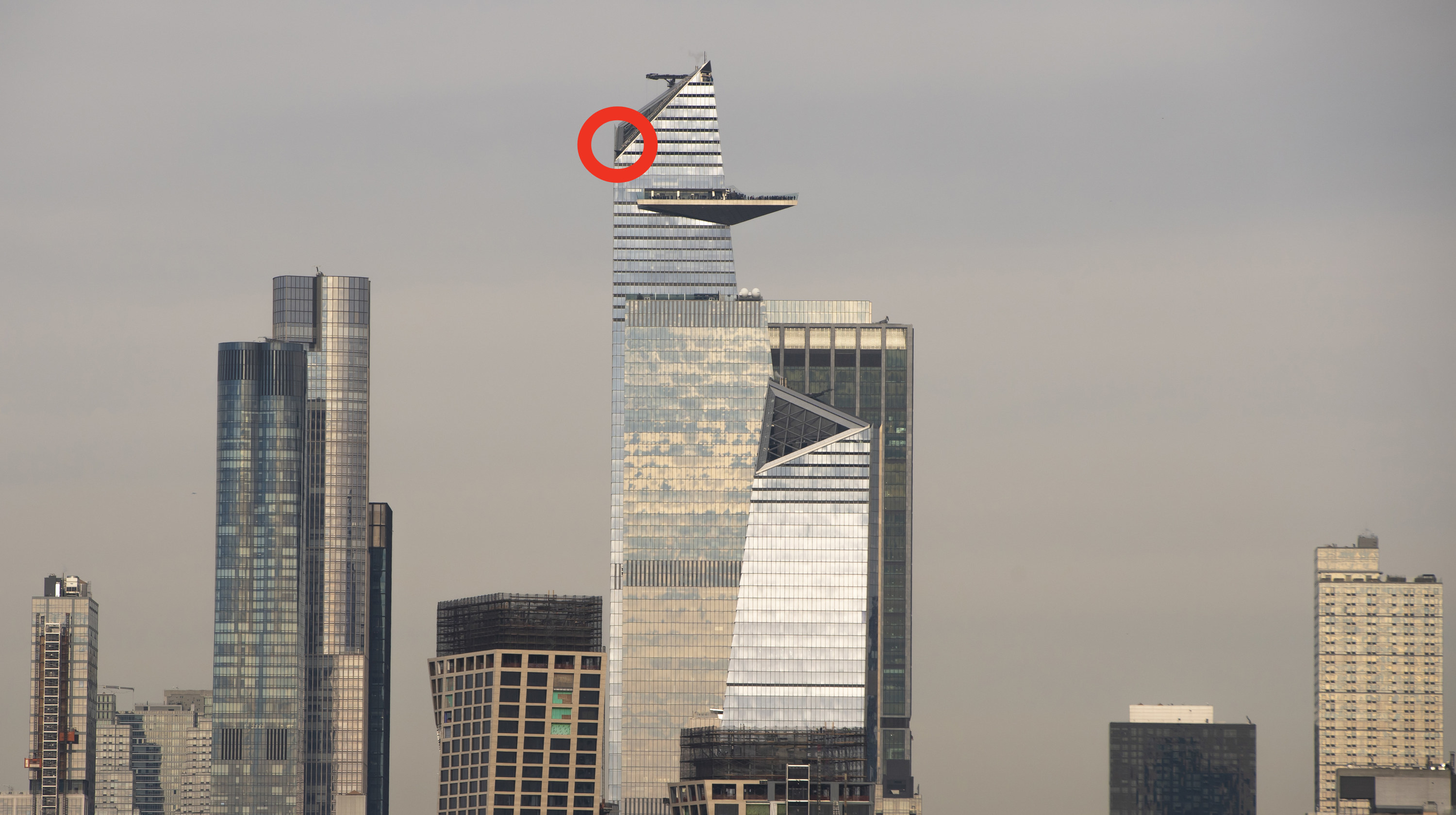 A wide view of the skyscraper, with the area at the start of the vertical climb circled