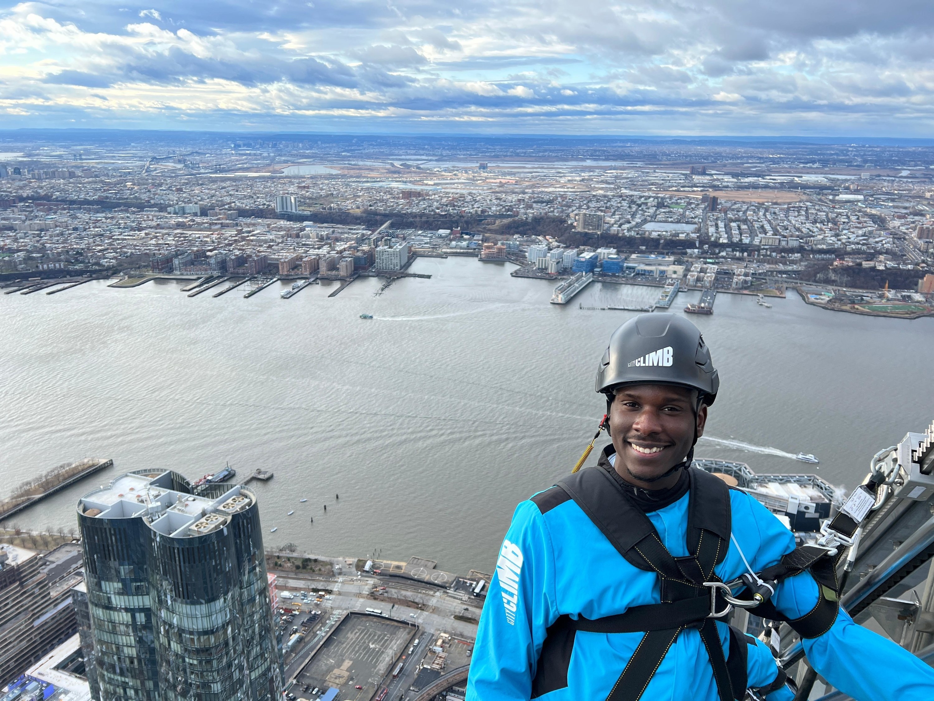 Terry smiling while on the skyscraper railing