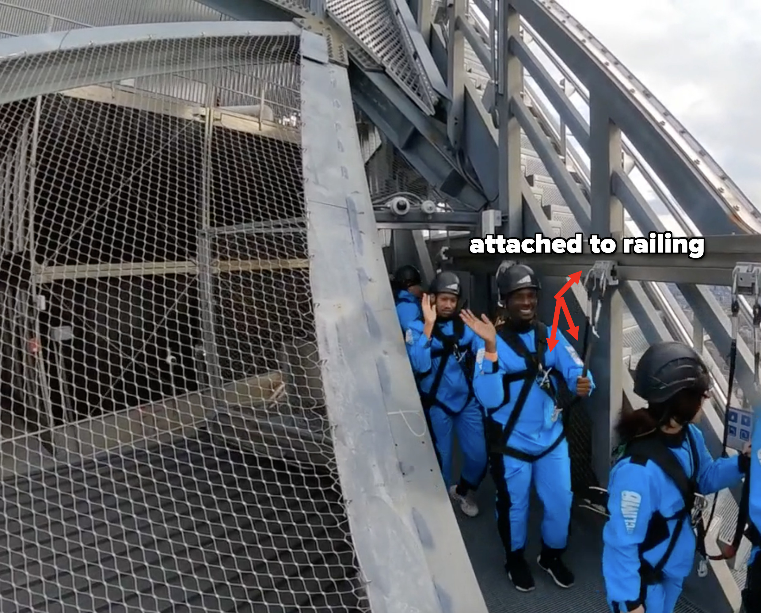 Terry and Ajani waving while attached to a railing