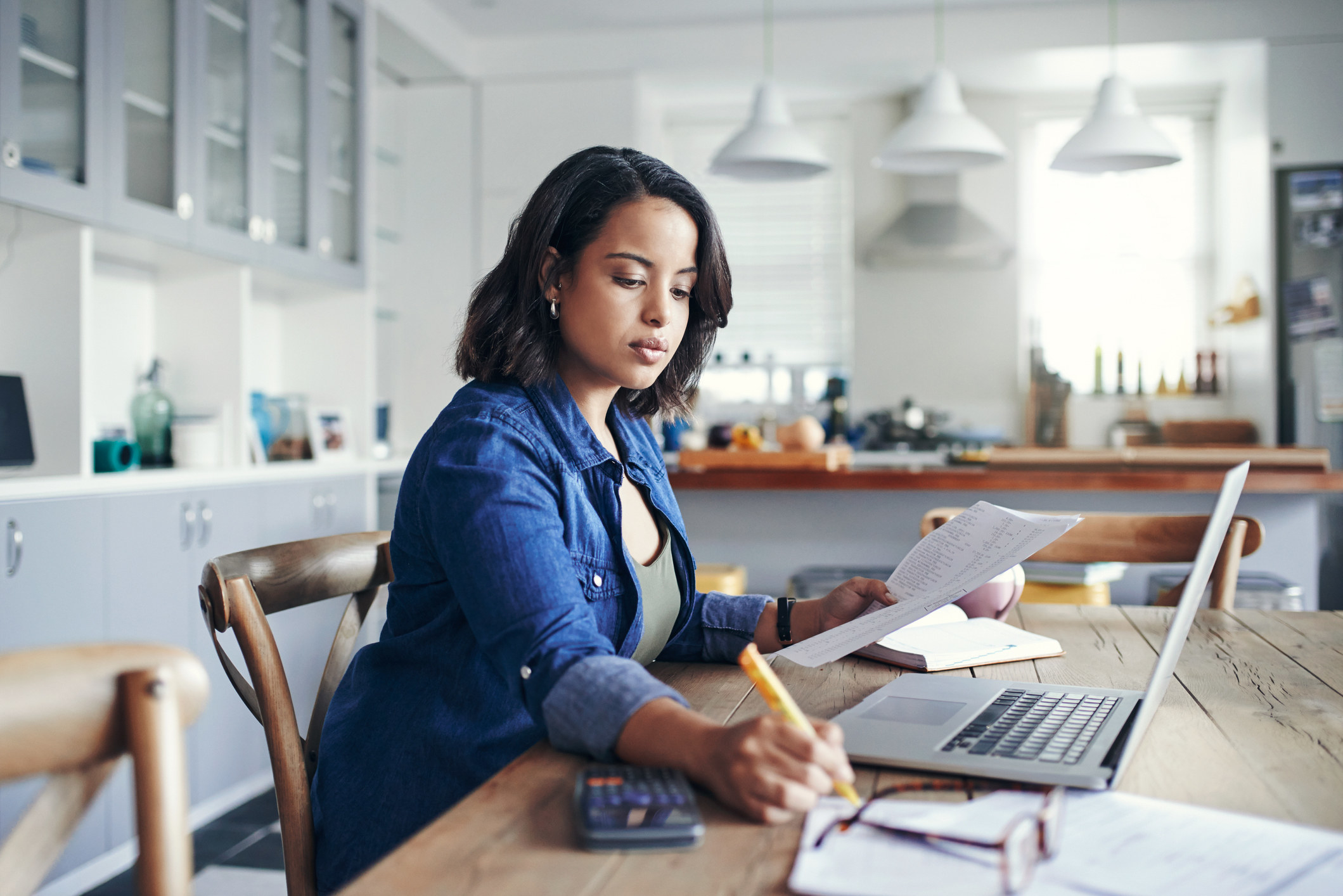 A woman doing work in front of her laptop