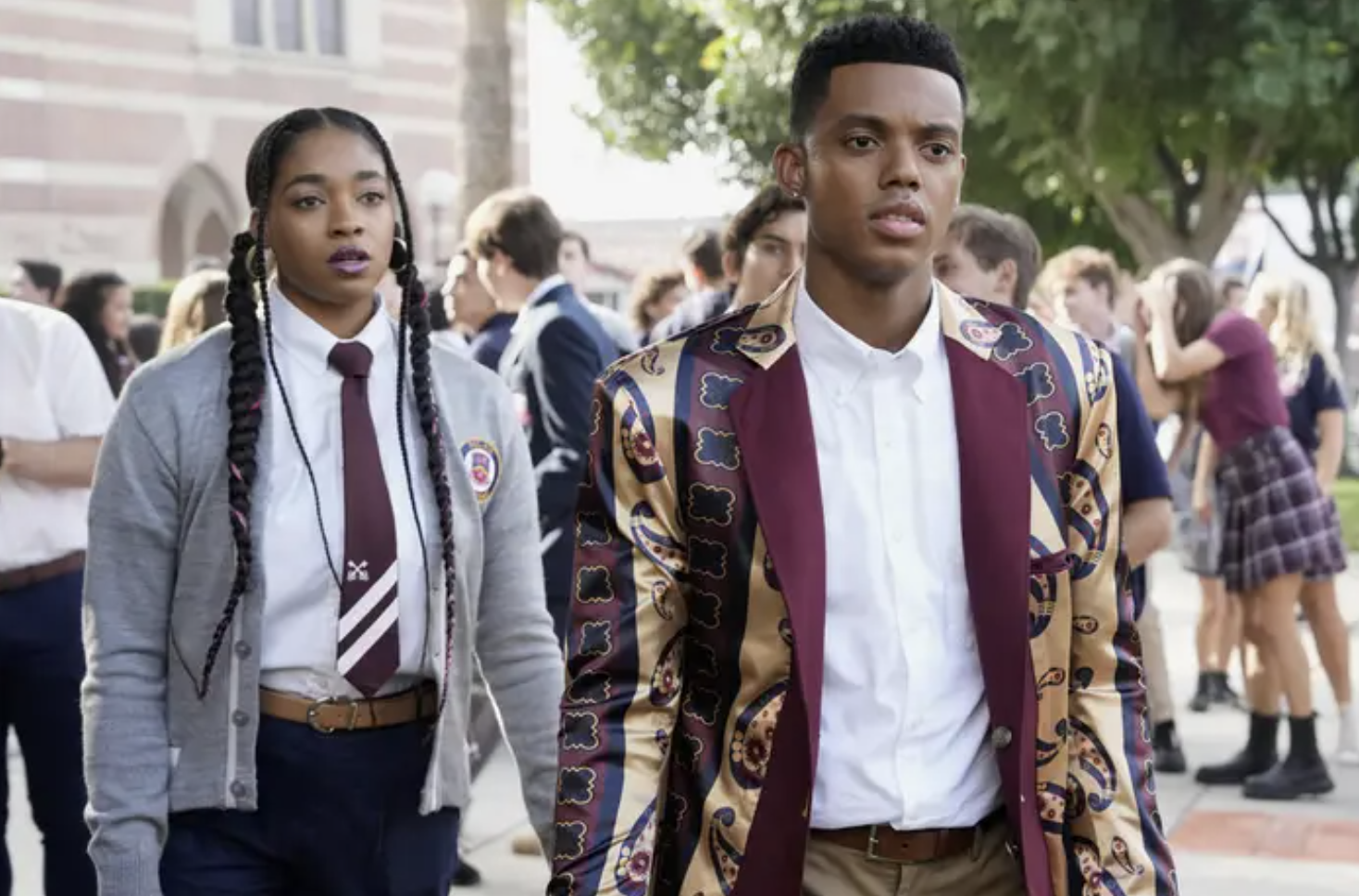 a still from the tv show Bel-Air; two prep school students stand in a high school courtyard