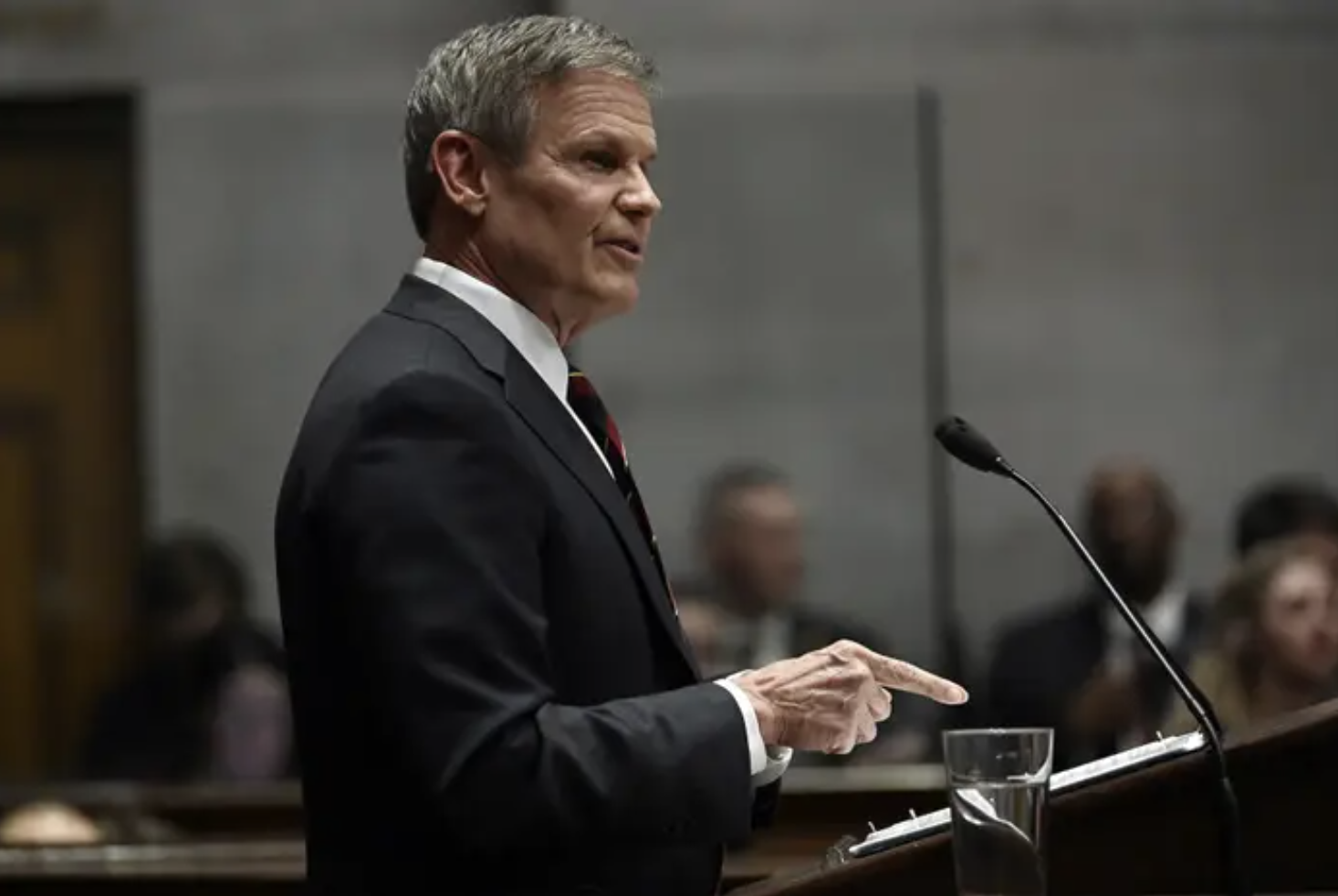 Tennessee Gov. Bill Lee in a suit in front of a podium