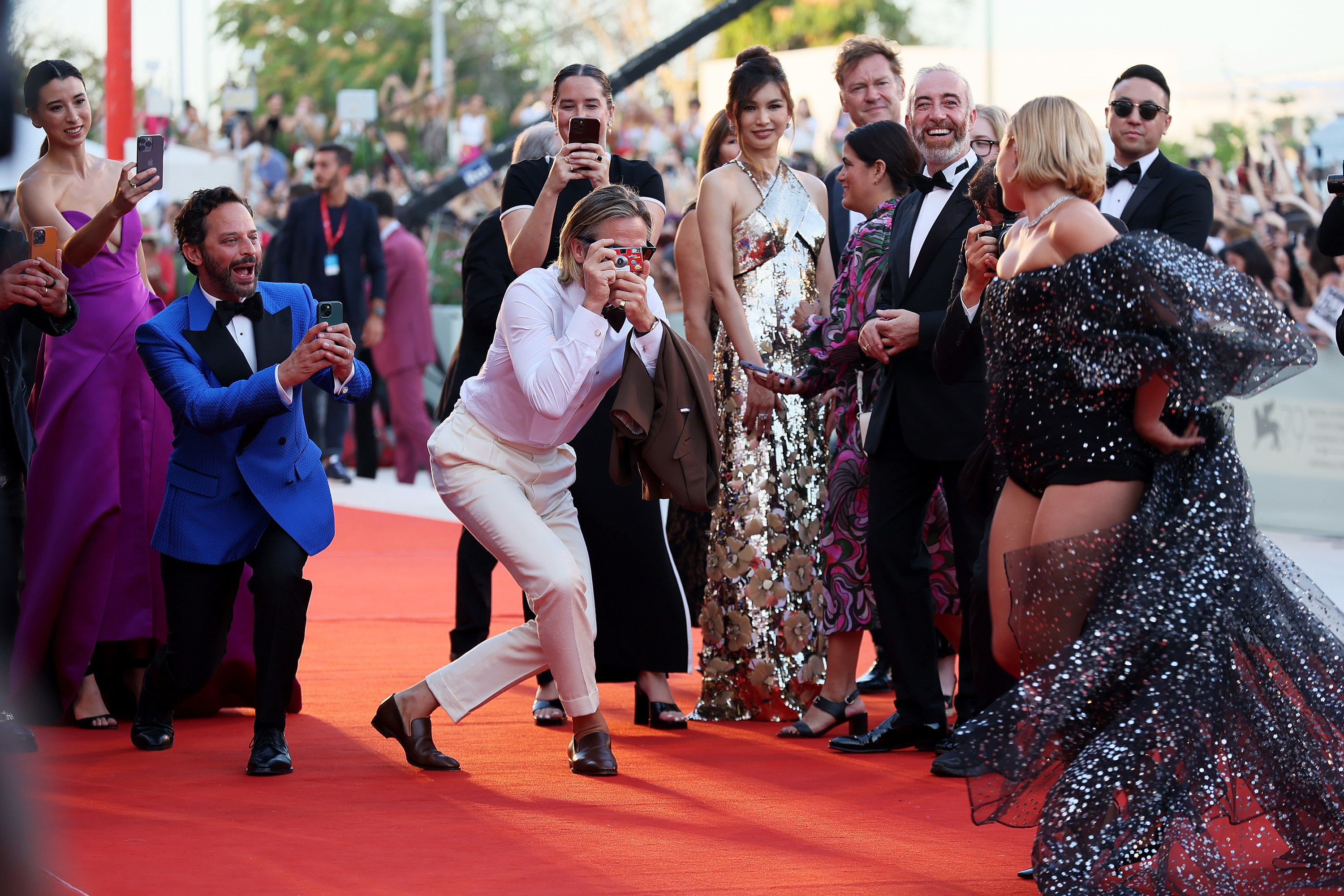 Chris and cast member Nick Kroll dramatically take photos of Florence Pugh as she poses on the red carpet