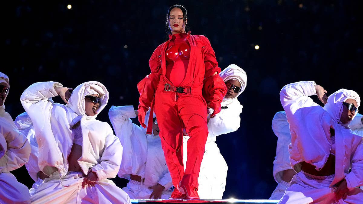 For her Super Bowl halftime performance, RIhanna donned a custom flight-inspired look created by Loewe in a bright bold red to match the stage set.