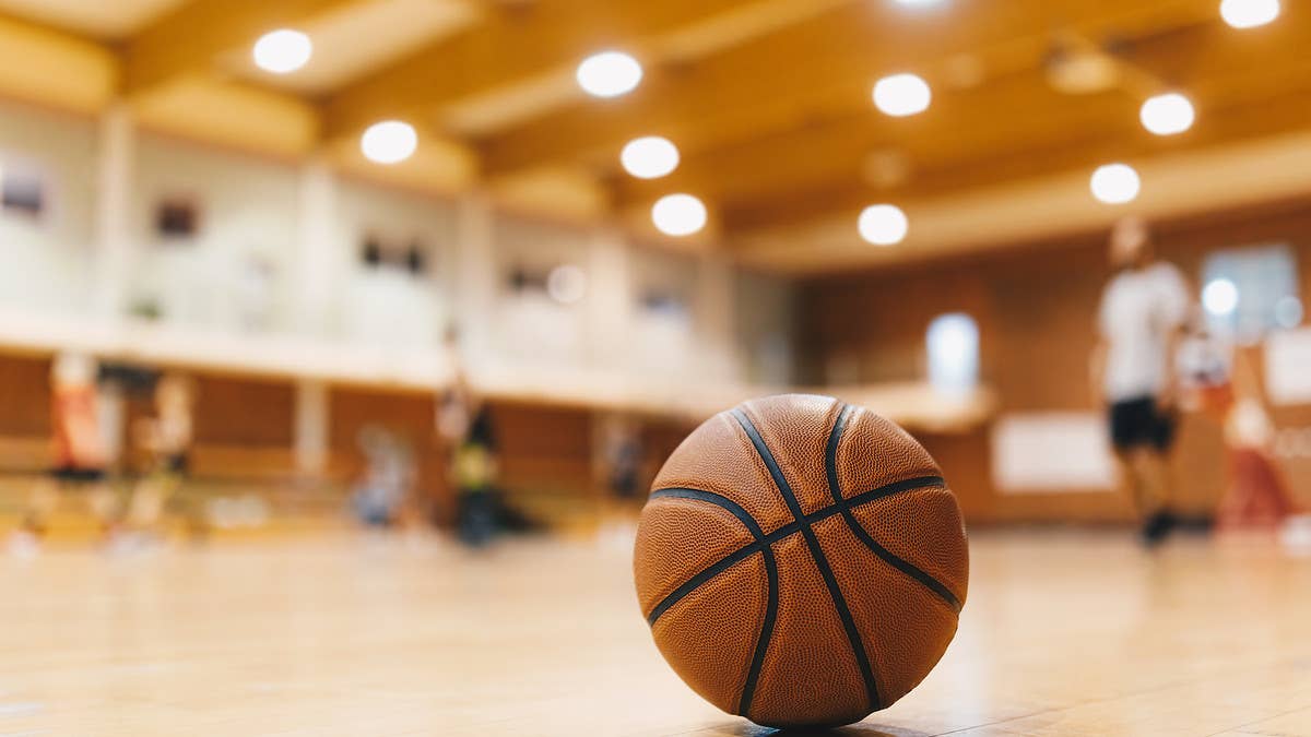 A Virginia high school basketball coach has landed himself in hot water after he was captured on video launching himself at a spectator in the stands.
