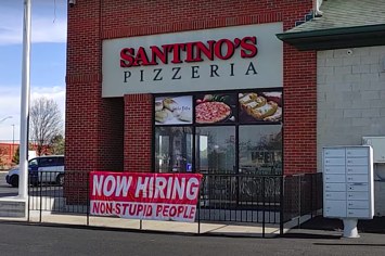 Outside view of pizza shop with viral sign