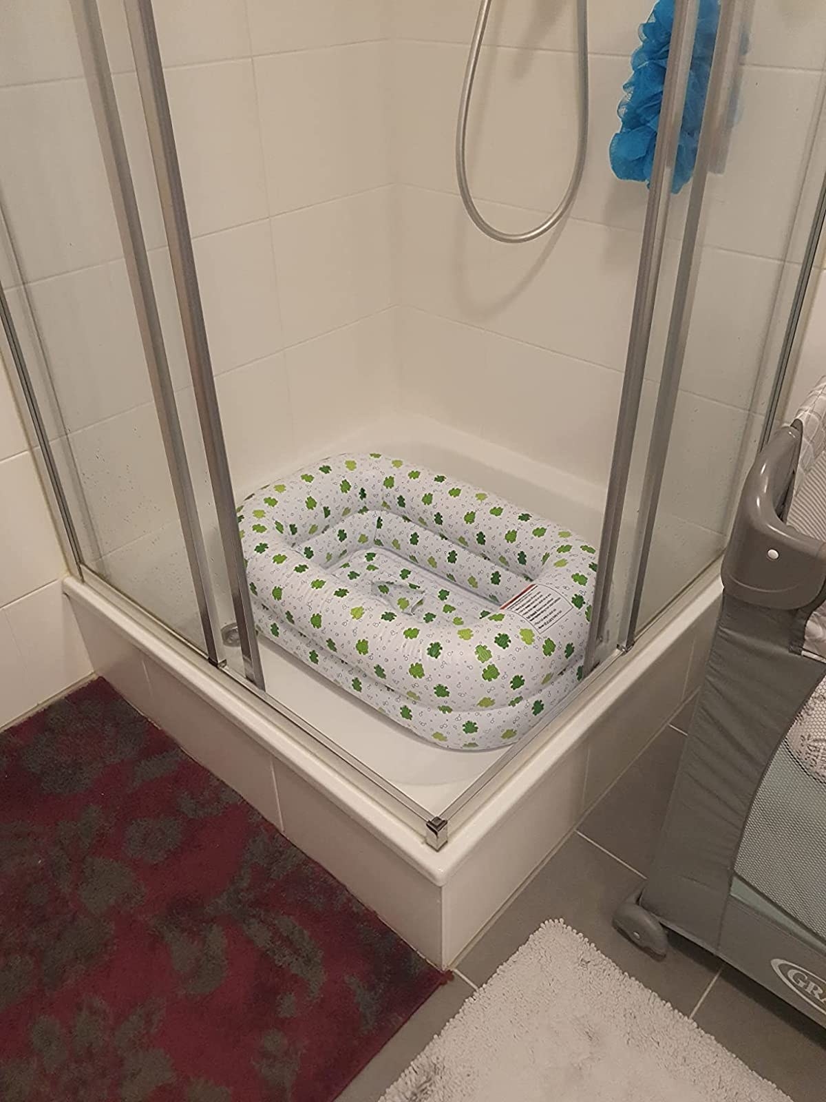 Reviewer&#x27;s photo of white with green frog design inflatable bathtub in shower