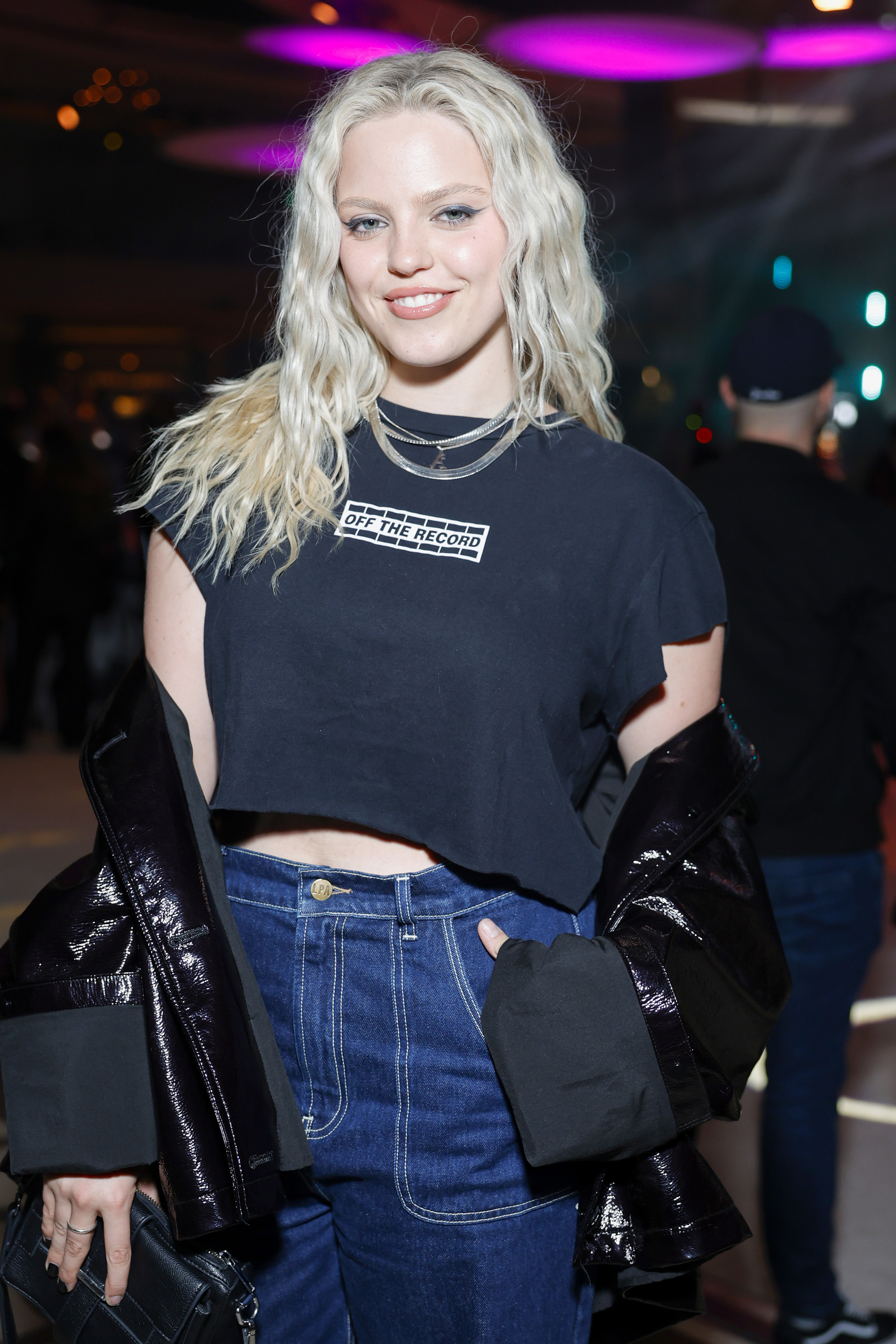 Reneé smiles as she poses for a photo at an event