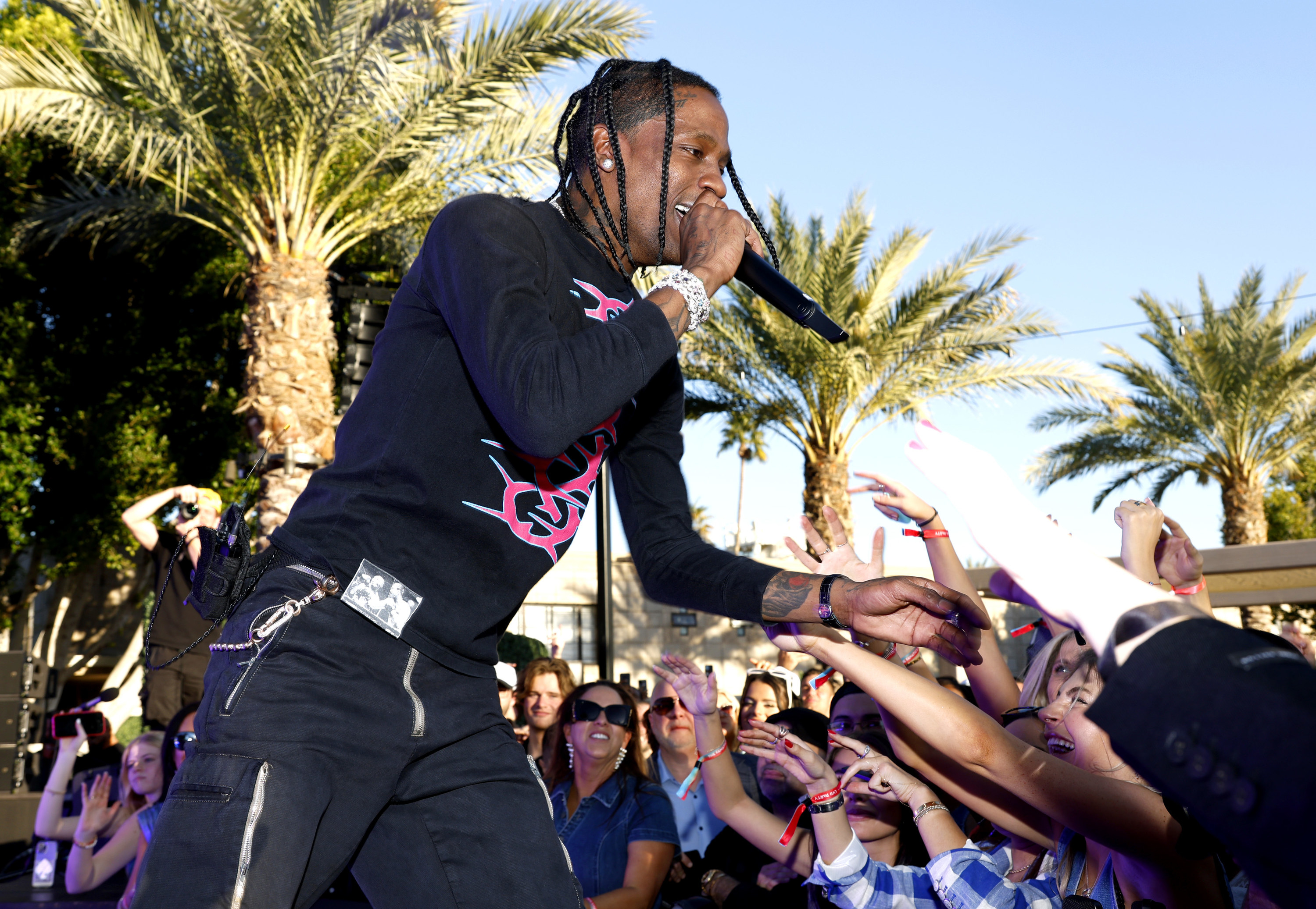 Travis interacting with the crowd at an outdoor performance