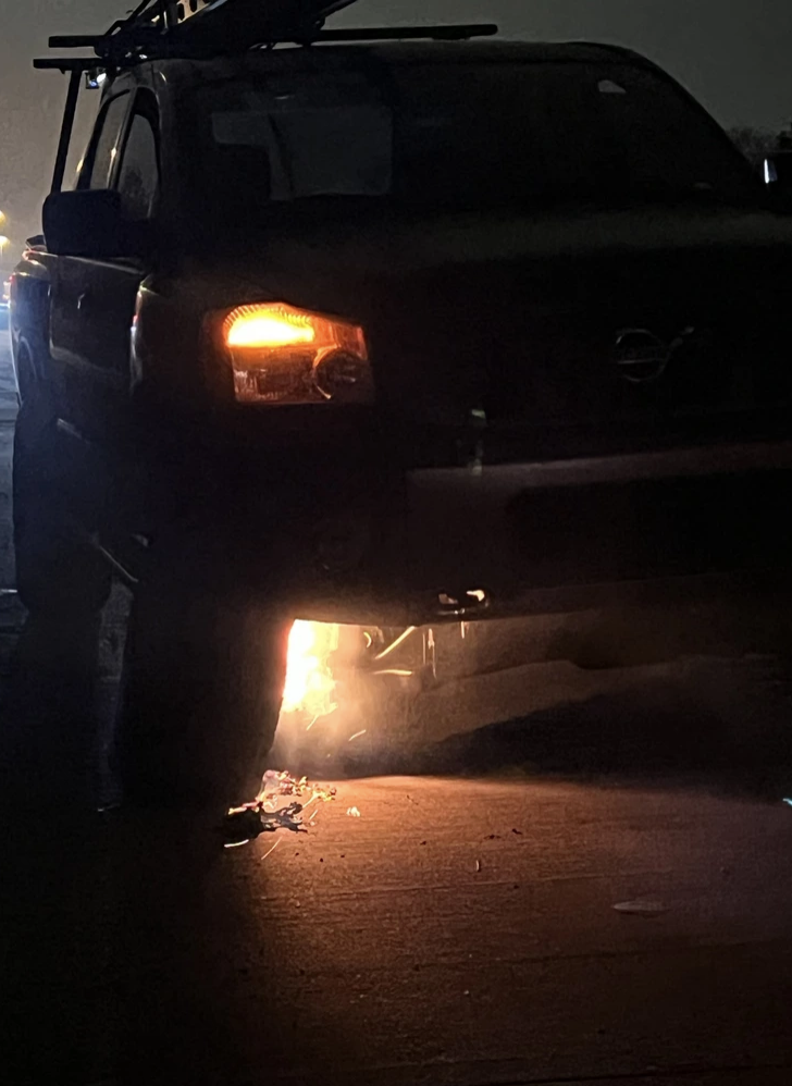 An SUV with a fire underneath it