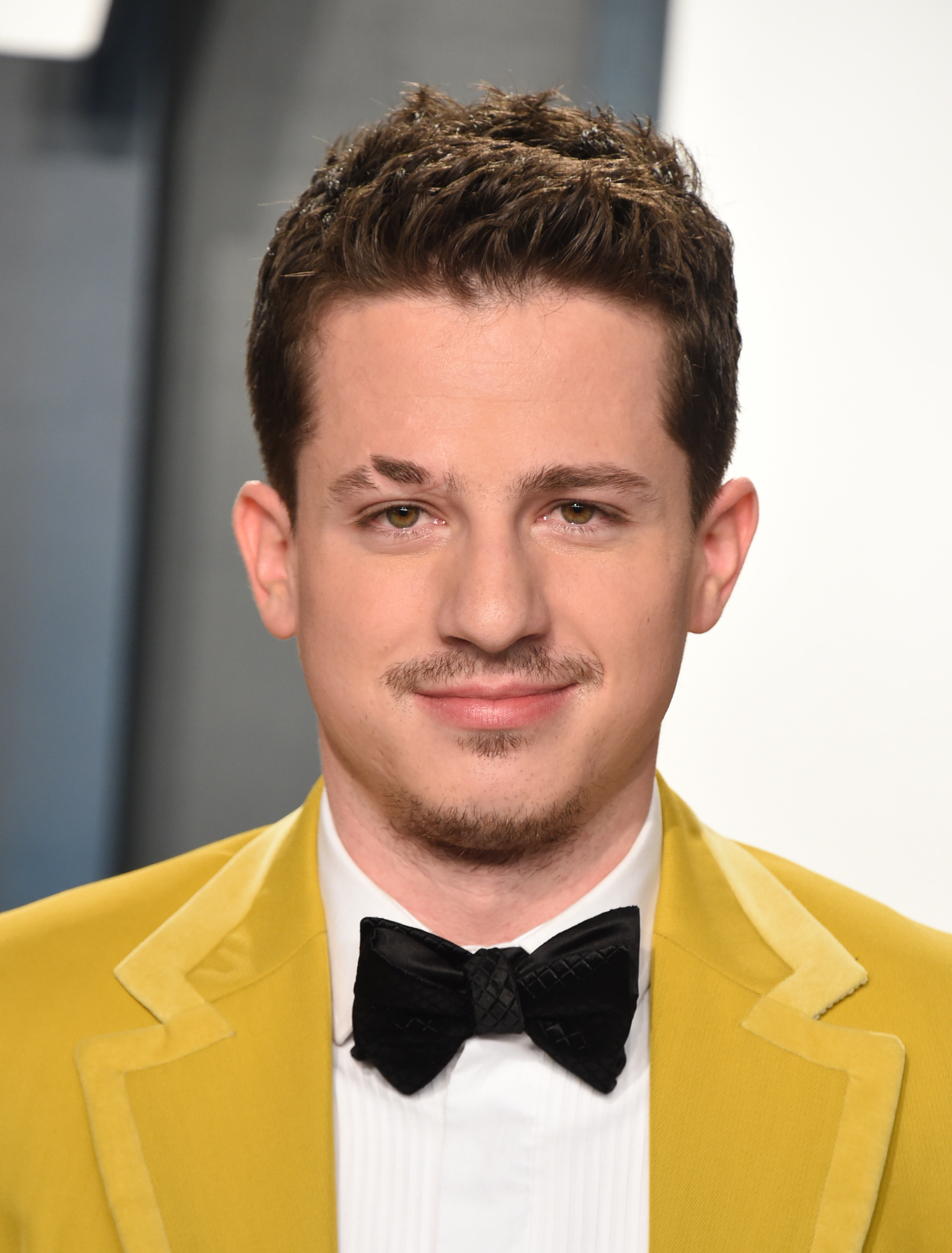 Charlie Puth posing on a red carpet