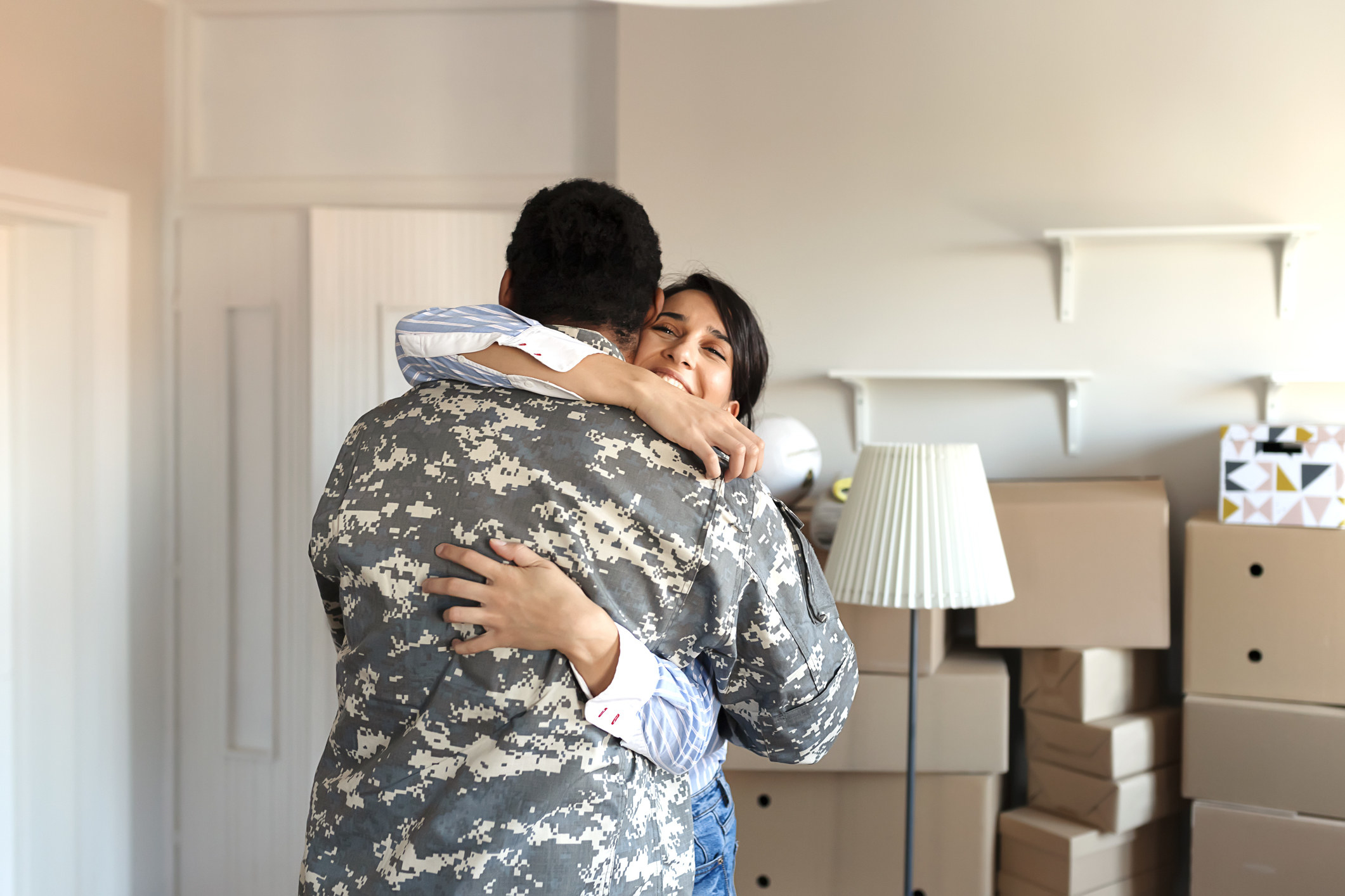 A man in military gear hugging a woman