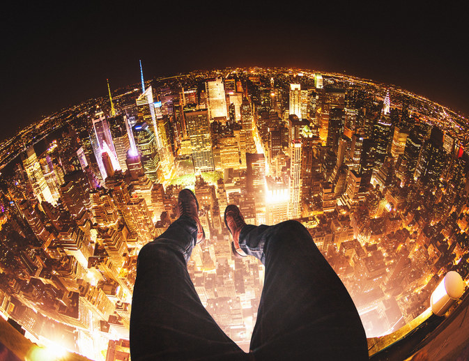 Feet hanging over a city