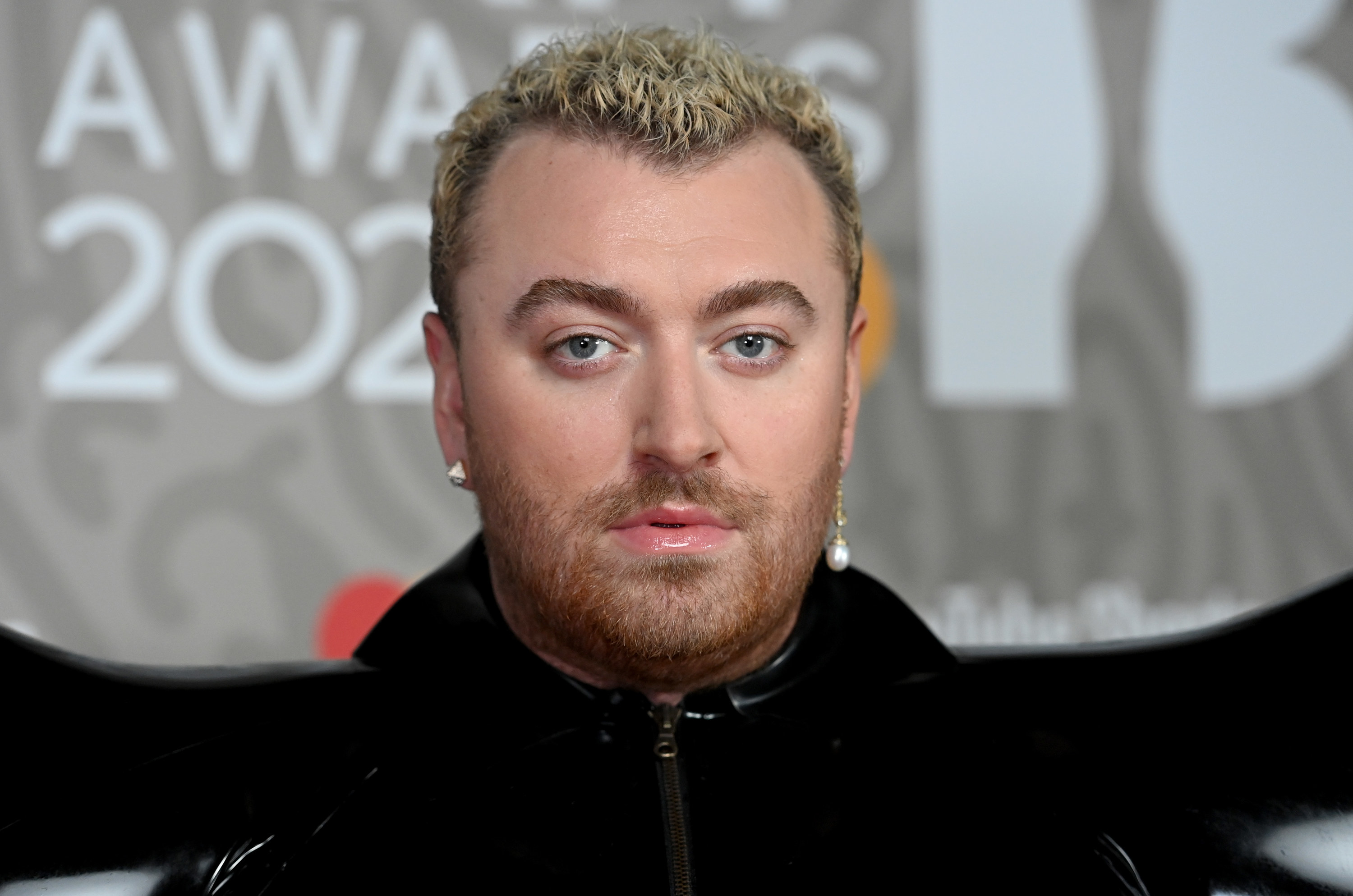 Sam Smith posing on a red carpet
