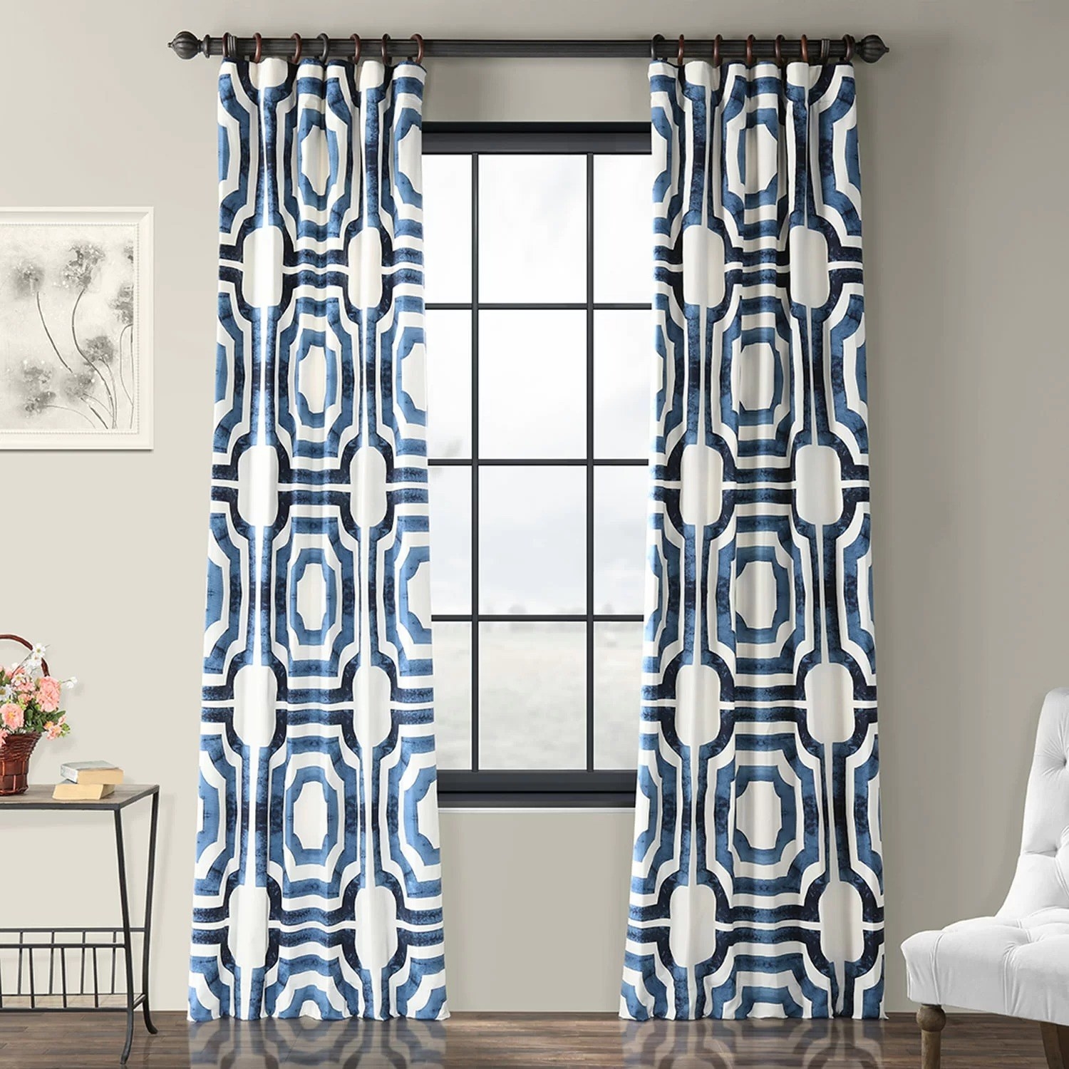 One curtain  panel with a geometric pattern on either side of a living room window