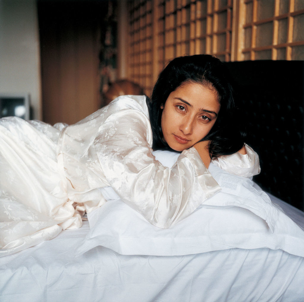 Actress Manisha Koirala lays her head on a pillow