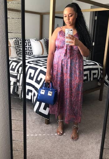 reviewer wearing the same dress in a blue and pink leaf print design