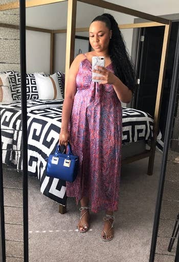 reviewer wearing the same dress in a blue and pink leaf print design