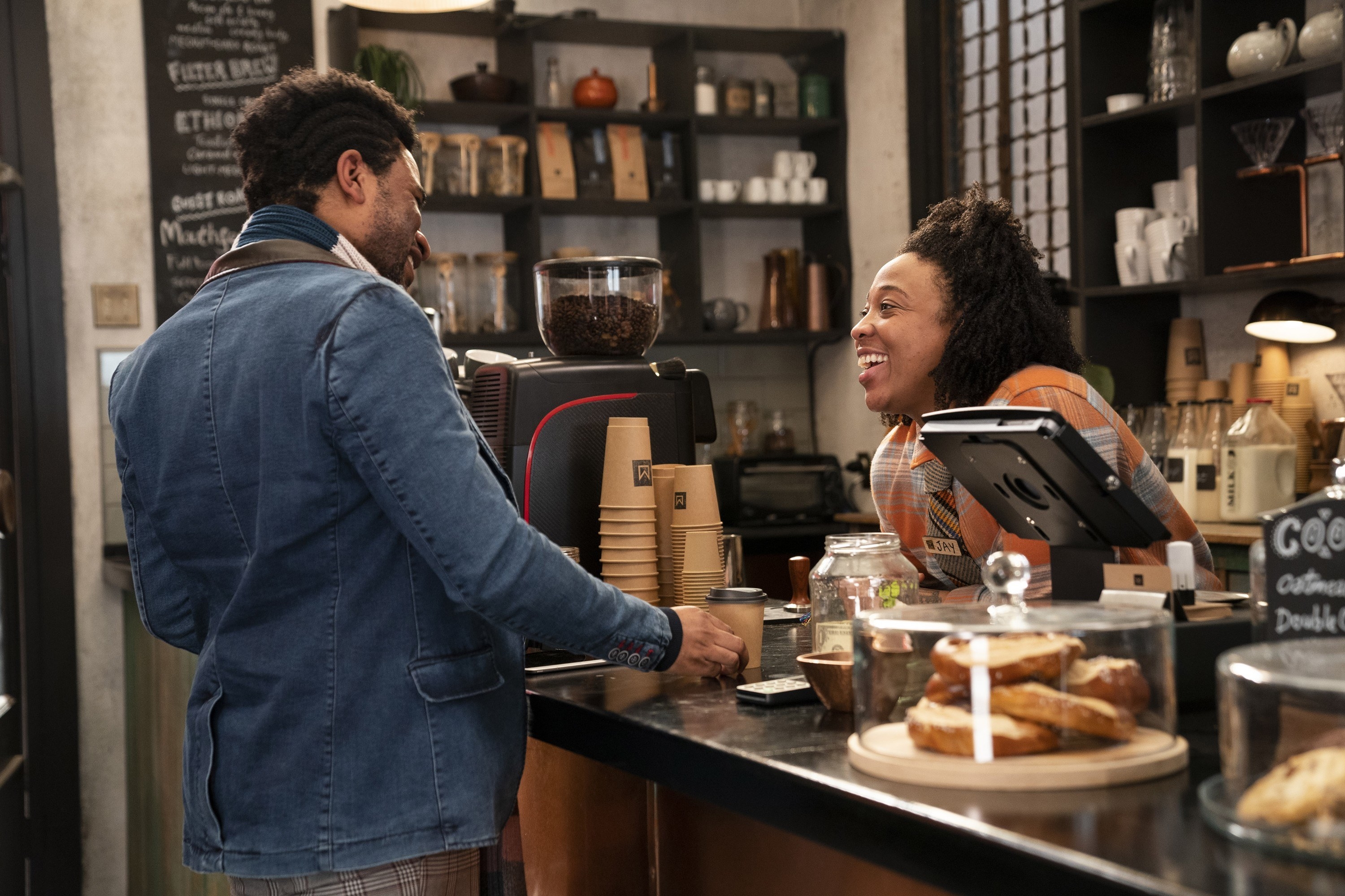 A barista making small talk with a customer