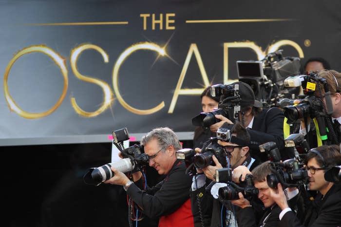 A line of photographers and camera crew along the red carpet