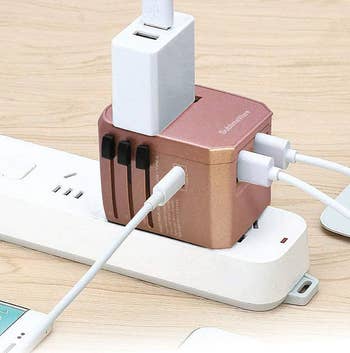 the rose gold adapter in use with various devices plugged in