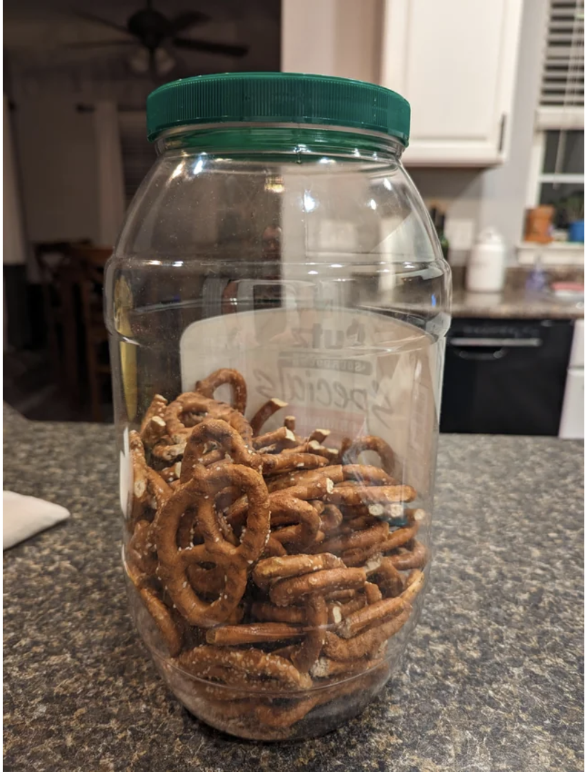 A half-eaten jug of pretzels