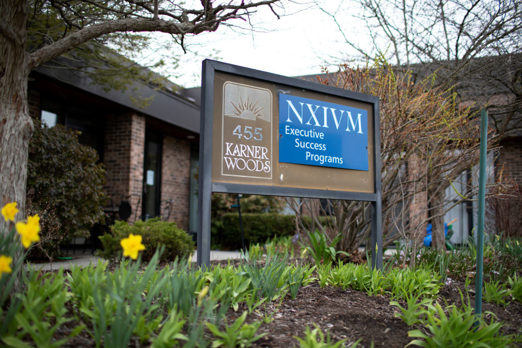 A NXIVM Executive Success Programs sign outside a building