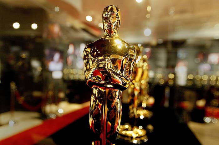 A closeup of a line of Oscar statues