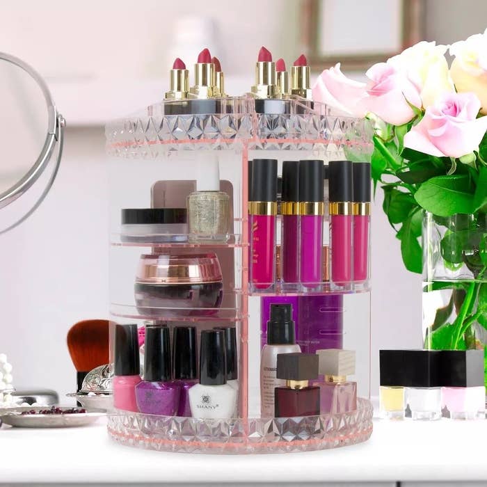 the pink makeup organizer with cosmetics on it